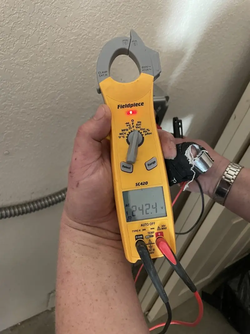Voltage testing with clamp meter during Recessed Lighting Installation in Price